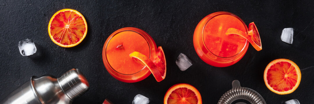Orange cocktails panorama with ice cubes, shot from above