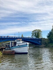 Naklejka premium Pleasure boat and a little boat on the River Severn and the bridge in the background.