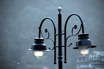 Beautiful picture of black road side lamp in india. Background Blur