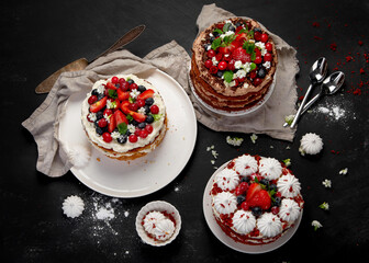 Assorted delicious and colorful homemade cakes with different type of filling on black background.