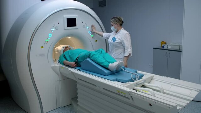 Doctor doing mri scan to patient woman