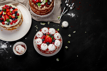 Assorted delicious and colorful homemade cakes with different type of filling on black background.