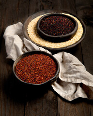 Set with different types of quinoa on dark background. Organic food concept.