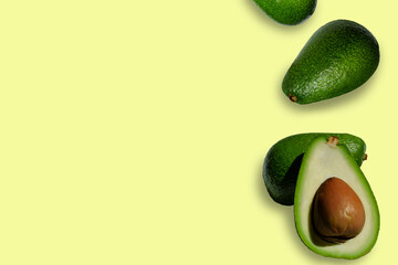 yellow background with avocado, place for text on the side is avocado