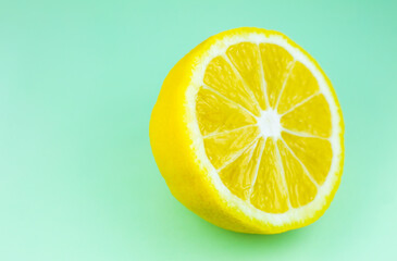 Close up photo of lemon texture on the blue background. Fruit cut in half, inside, macro view. Beautiful natural wallpaper.