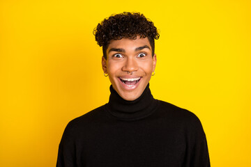 Photo of cute funky dark skin man wear black sweater open mouth big eyes isolated yellow color background