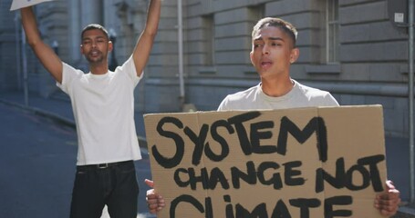 Two mixed race men on a protest march holding placards raising hands and shouting