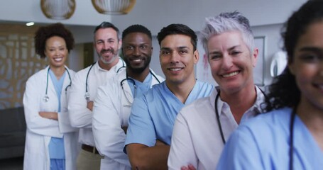 Portrait of diverse male and female doctors standing in hospital corridor smiling to camera - Powered by Adobe