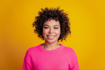Young woman beaming shiny smile on yellow background