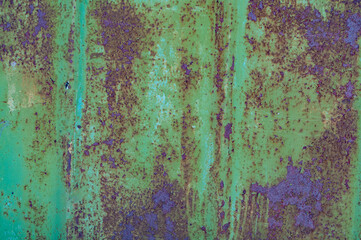 Vintage background with rusty iron sheet with shabby faded green paint closeup, rough textured surface old metal material