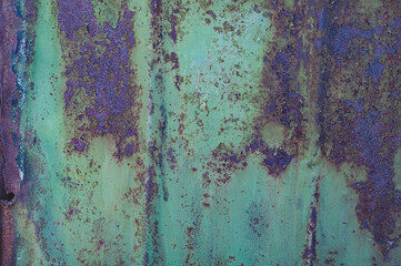 Vintage background with rusty iron sheet with shabby faded green paint closeup, rough textured surface old metal material