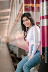 Asian female tourists are taking her to places of joy, emotional excitement, using public rail transport.