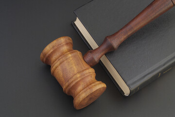 Gavel and legal book on wooden table