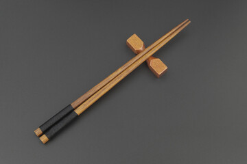 Wooden chopsticks on wooden table with space for text
