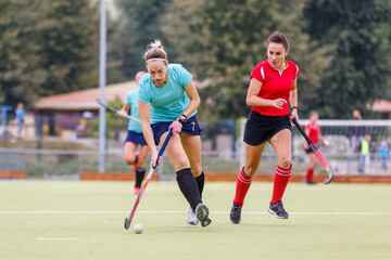 Fototapeta premium Two field hockey female players struggle for ball