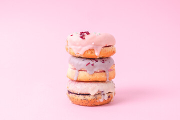 Tempting donuts dessert with iceing and sprinkles. Sweet sugar round doughnuts of different flavours. Top horizontal view copyspace. Healthy diet and junk food concept