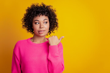 Portrait of cunning flirty promoter girl point finger copyspace isolated over yellow color background