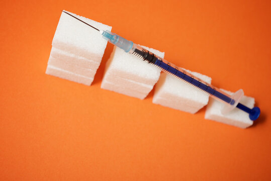 Sugar cubes and syringe