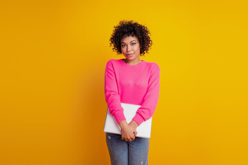 Portrait of girl with laptop posing look camera on yellow background