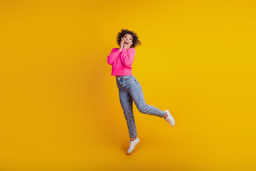 Fototapeta na wymiar Portrait of active positive girl jumping have weekend free-time fun isolated on yellow background