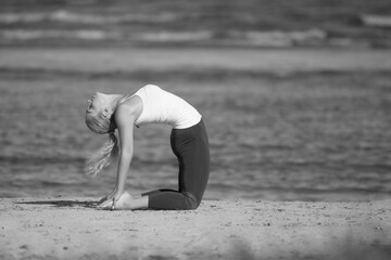 Woman doing yoga at the sea