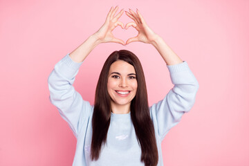 Naklejka premium Photo of nice optimistic long hairdo brunette lady show heart wear blue sweater isolated on pastel pink color background