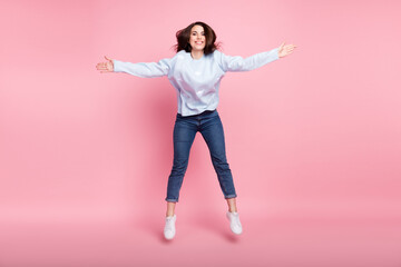 Full size photo of nice optimistic long hairdo brunette lady jump hug wear blue sweater isolated on pink background