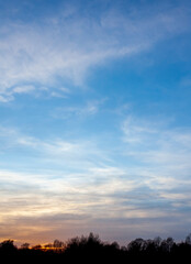 Fototapeta na wymiar Sunset in the sky with a dark silhouette 