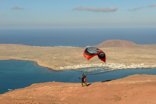 Man during departure with his parapent at Mirador del Rio on Lanzarote island in Spain