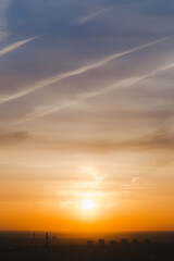 Beautiful bright summer sunset sky, yellow, orange and blue color natural background, vertical picture
