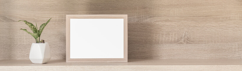 Square wooden frame with white mockup on vintage wooden shelf