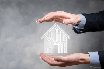 Businessman hold house icon.Smart home controlled, intelligent house, and home automation app...