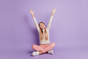 Little lady child sit floor isolated over purple background