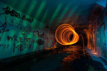 Steel wool shapes swirl light effect in a abandoned tunnel