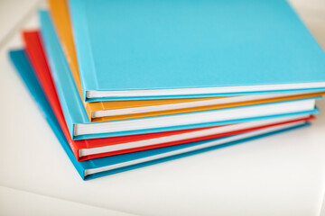 pyramid of multicolored books or photo albums. Place for the inscription. selling photographer's services or printing.