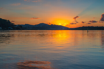 Sunrise waterscape with scattered clouds