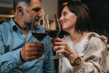 middle age couple drinking wine at home.