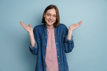 Young man smiling and gesturing while looking at camera