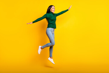 Fototapeta na wymiar Full size profile side photo of charming happy woman jump up make hands wings isolated on yellow color background