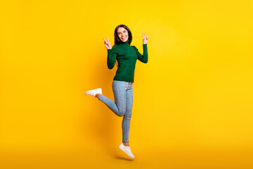 Fototapeta na wymiar Full body photo of happy cheerful brunette lady jump up make v-signs isolated on yellow color background