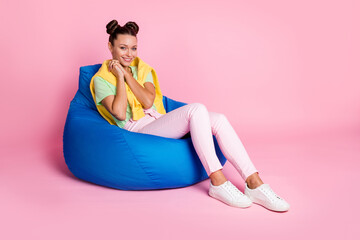 Photo of sweet dreamy young woman wear green t-shirt sitting beanbag arms together chin isolated pink color background