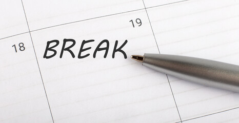 Text BREAK written on calendar planner to remind you an important appointment with a pen on isolated white background.