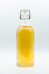 glass bottle containing tea isolated on white background