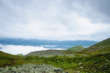 Fototapeta na wymiar highland mountain landscape with copy space - nature, outdoor, adventure, trekking, hiking, mountaineering concept image in mount Kazbegi, Georgia