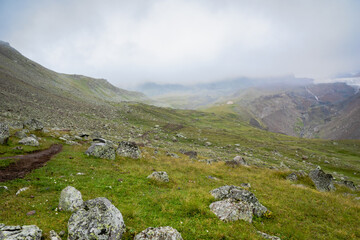 Fototapeta na wymiar highland mountain landscape with copy space - nature, outdoor, adventure, trekking, hiking, mountaineering concept image in mount Kazbegi, Georgia