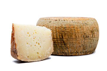 a piece of aged pecorino cheese with cheese wheel in white background