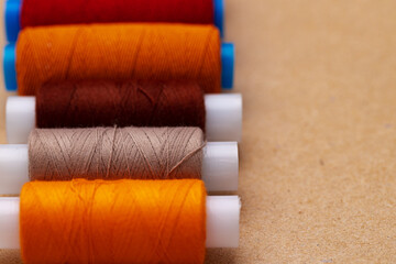 Many colored spools of threads as a background