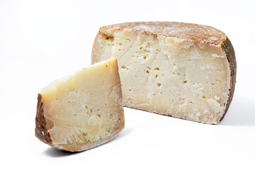 a piece of aged pecorino cheese with cheese wheel in white background - obrazy, fototapety, plakaty
