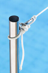 Obraz premium Wrong nautical knot. Stretched mesh, carabiner, knot, rope.