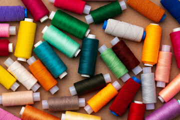 Many colored spools of threads as a background